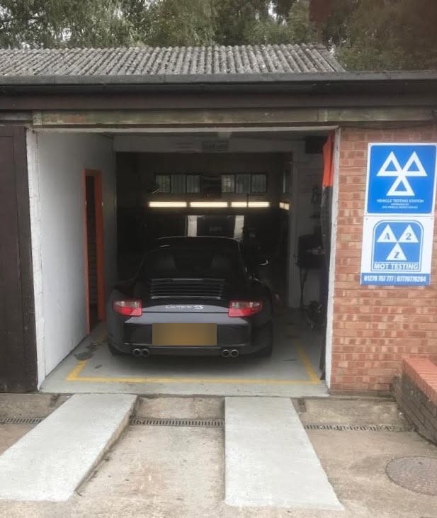 A Porsche 911 in the MOT bay
