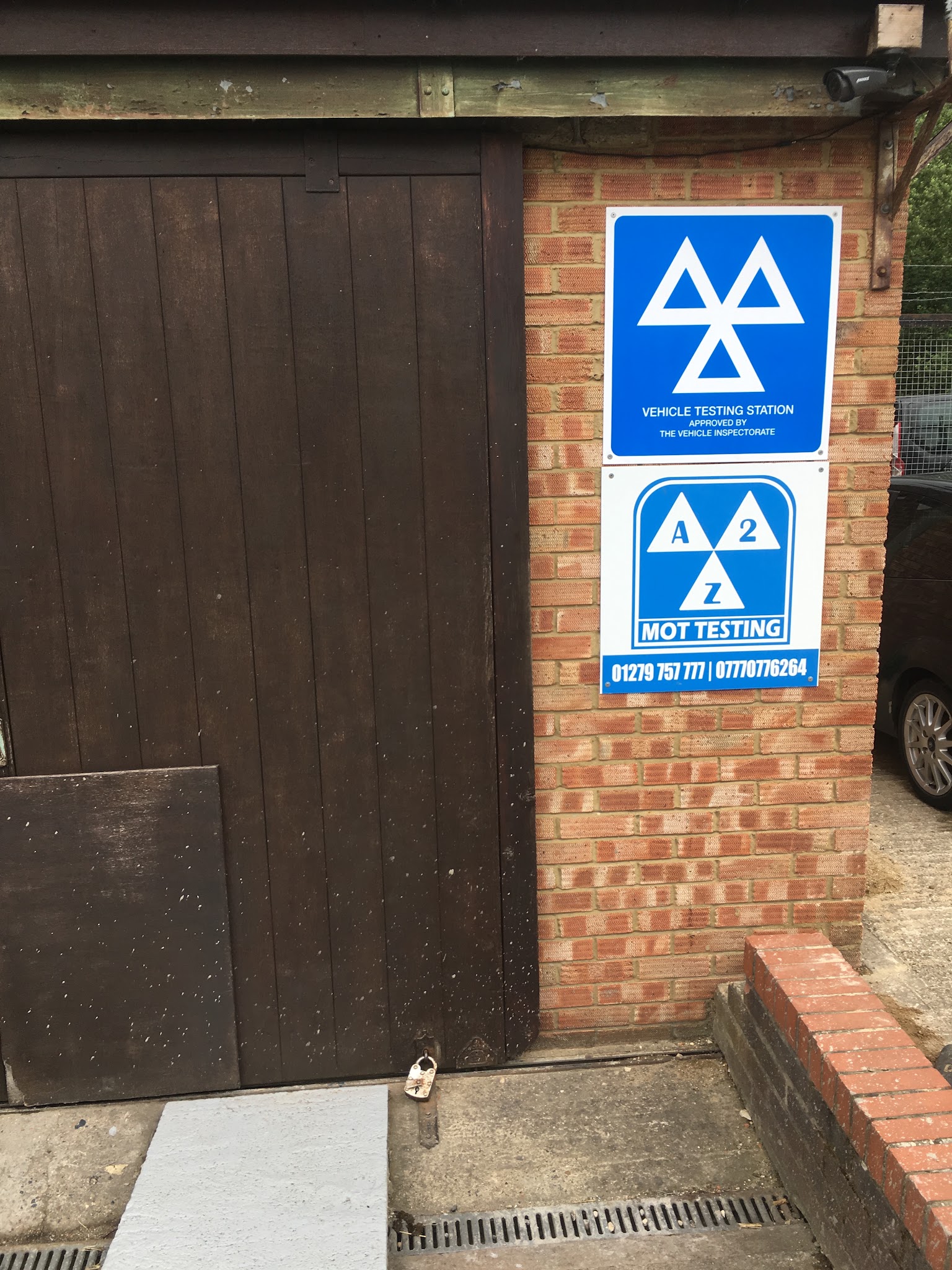 The A2Z MOT Testing sign and the Vehicle Testing Station sign beside the workshop door